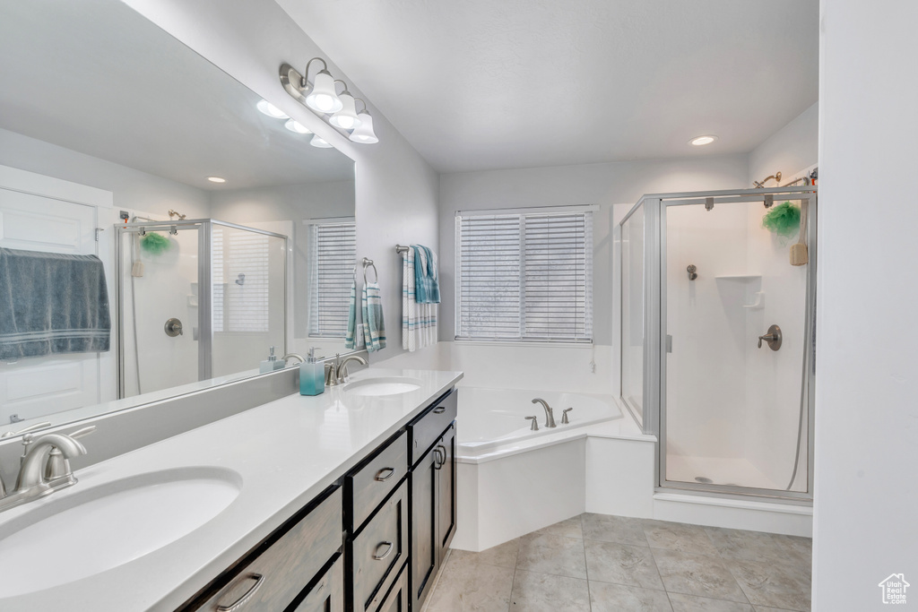 Bathroom with plus walk in shower, tile patterned floors, and vanity