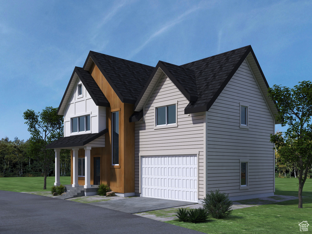 View of front facade featuring a garage and a front yard