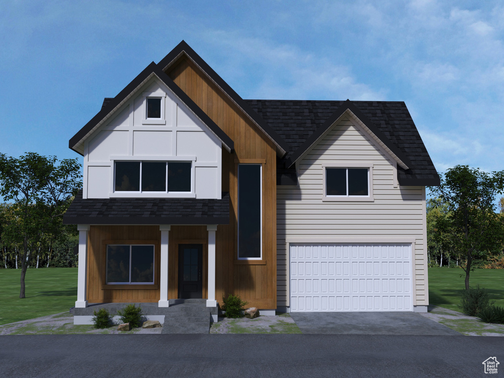 View of front of house with a garage and a front lawn