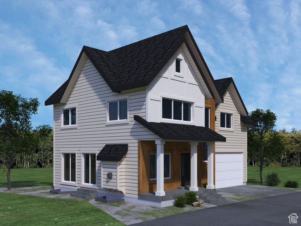 View of front facade featuring a garage and a front yard