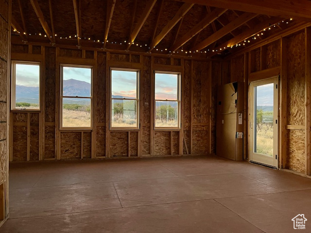 Empty room with a healthy amount of sunlight and a mountain view