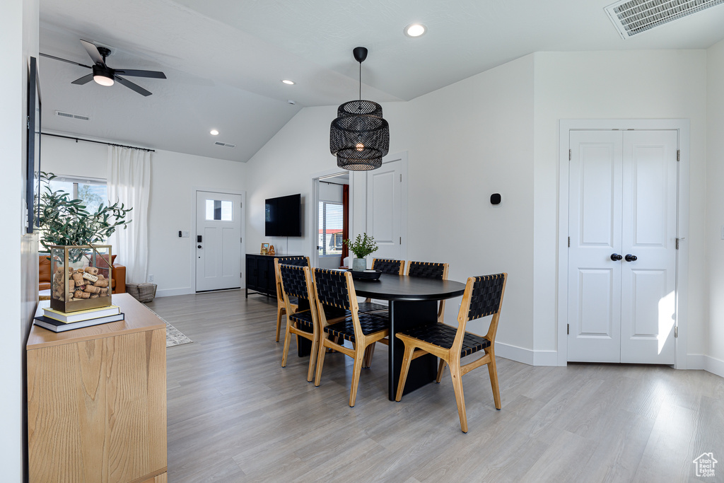 Dining space featuring light hardwood / wood-style flooring, ceiling fan, and vaulted ceiling