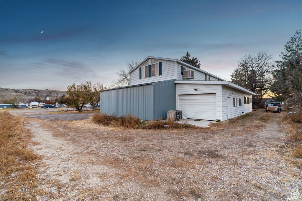 Property exterior at dusk with a garage