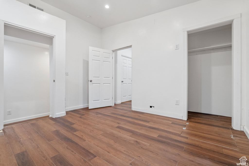 Unfurnished bedroom featuring hardwood / wood-style flooring