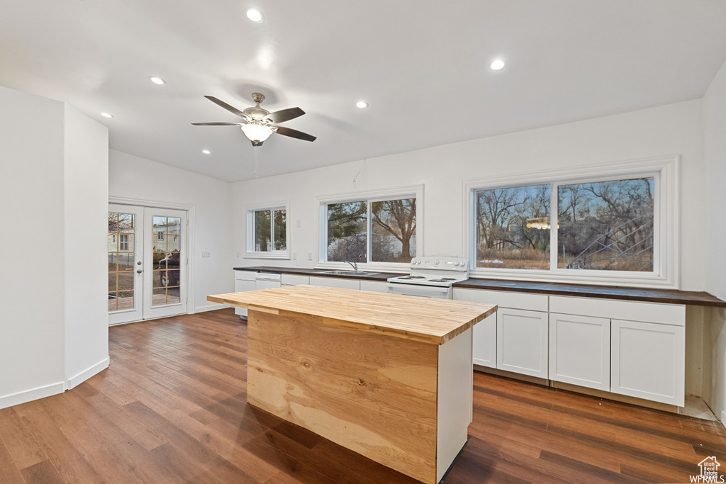 Kitchen featuring white electric range, dark hardwood / wood-style flooring, wood counters, and ceiling fan