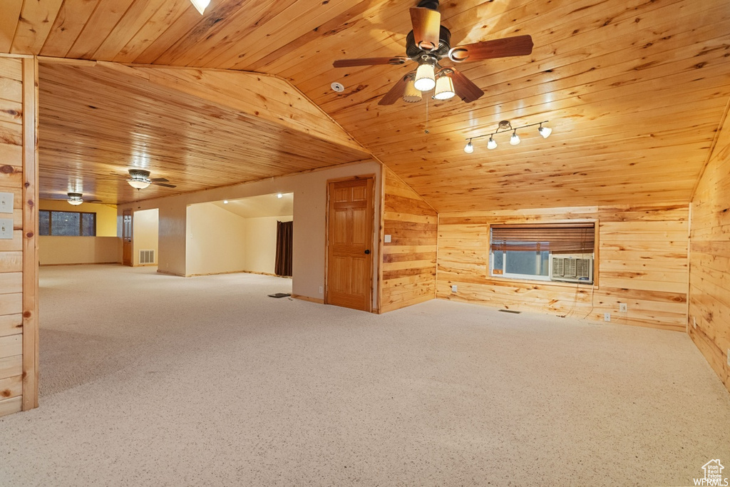 Interior space featuring wood ceiling, wooden walls, ceiling fan, and carpet floors