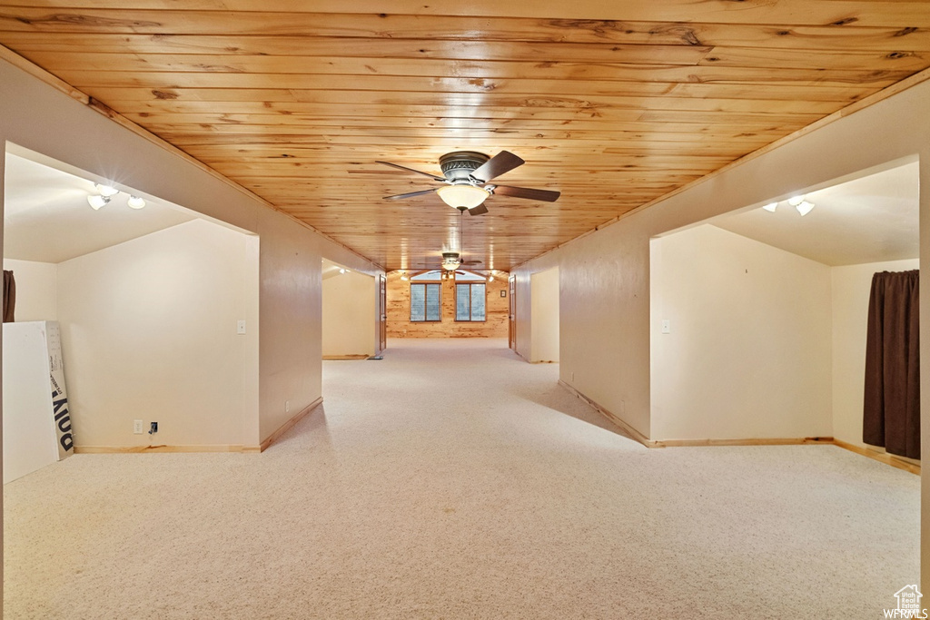 Interior space featuring track lighting, ceiling fan, wooden ceiling, and vaulted ceiling