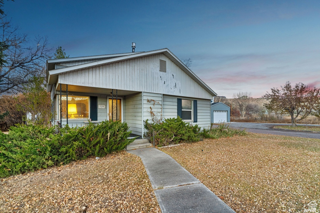 Bungalow featuring a porch and a garage