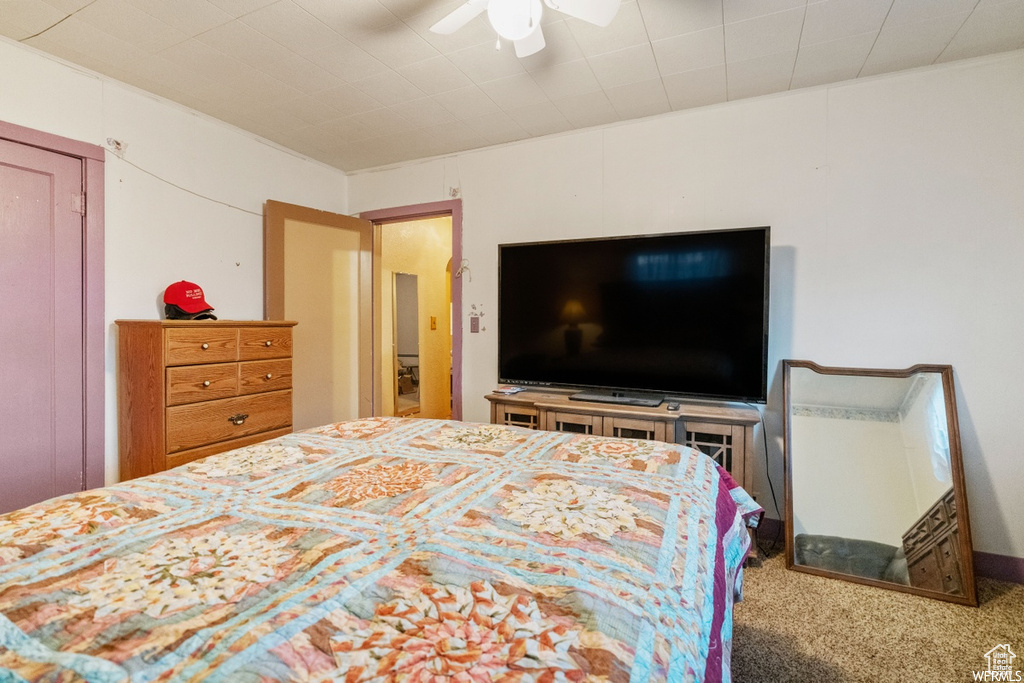 Carpeted bedroom with ceiling fan