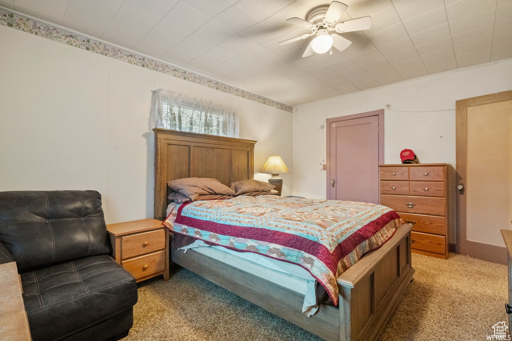 Bedroom with ceiling fan and light colored carpet