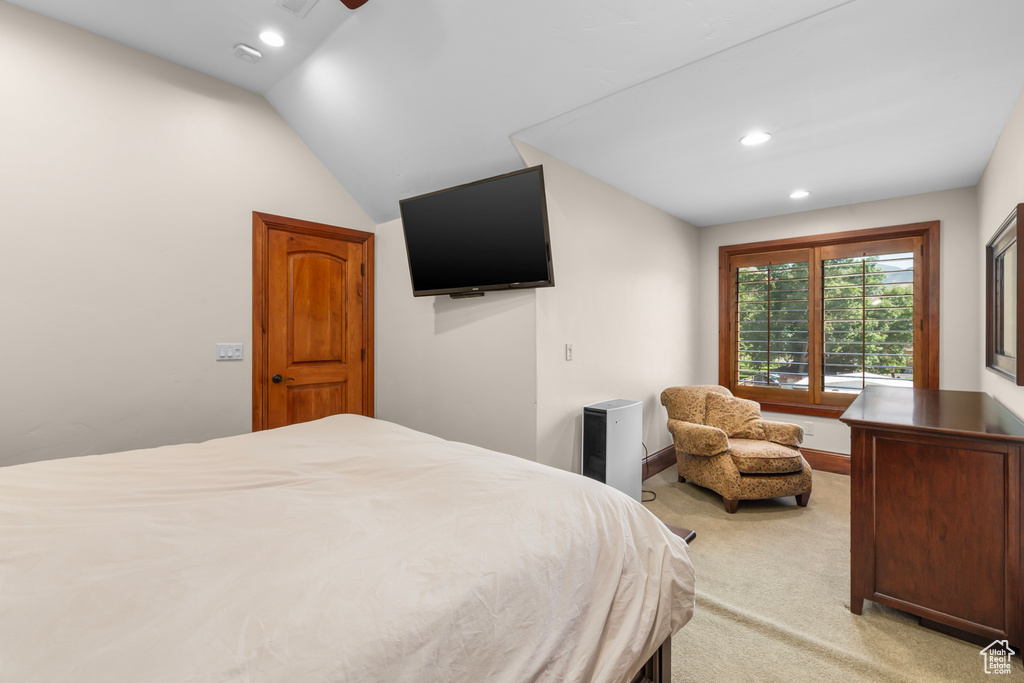 Bedroom featuring vaulted ceiling and light carpet