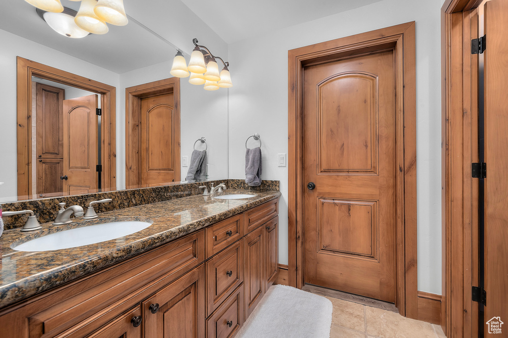 Bathroom with tile patterned flooring and vanity