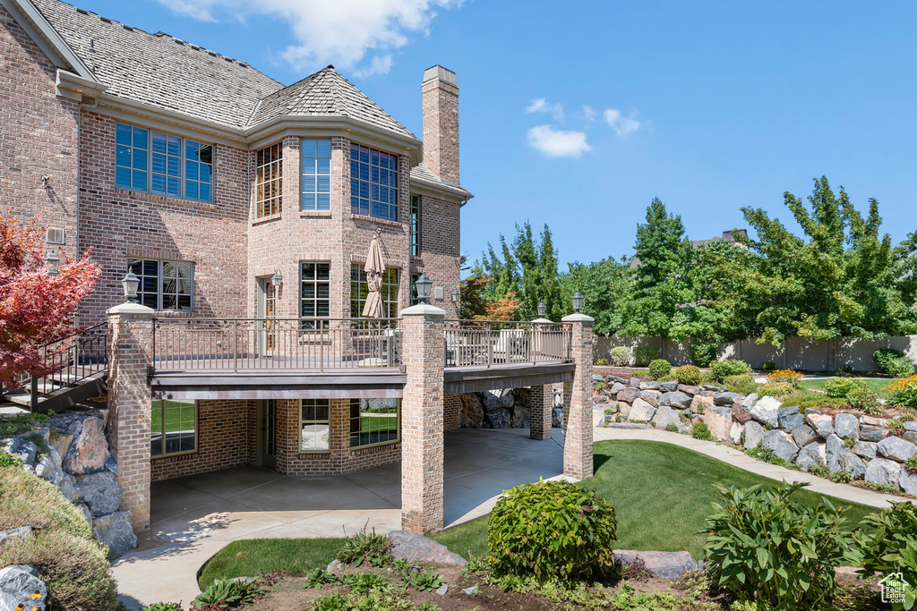 Back of property with a balcony