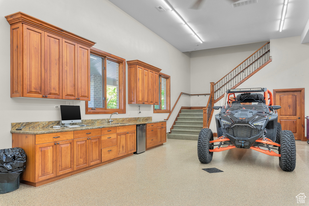 Kitchen featuring sink and light stone countertops