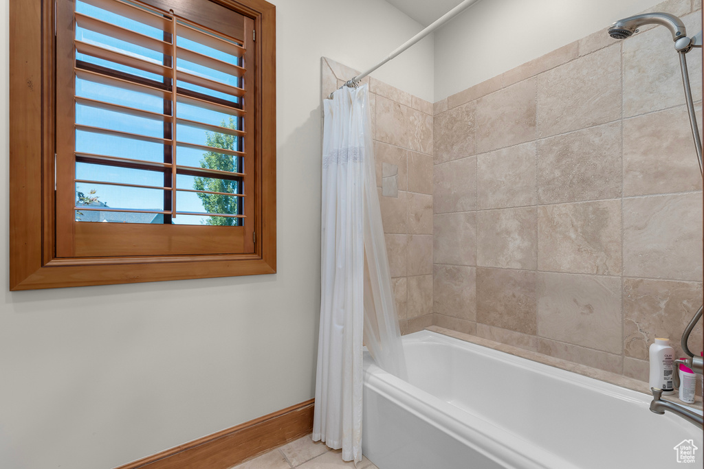 Bathroom featuring shower / tub combo and tile patterned floors