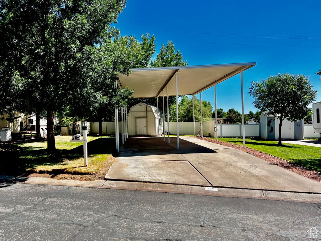 View of front of property with a front yard and a shed