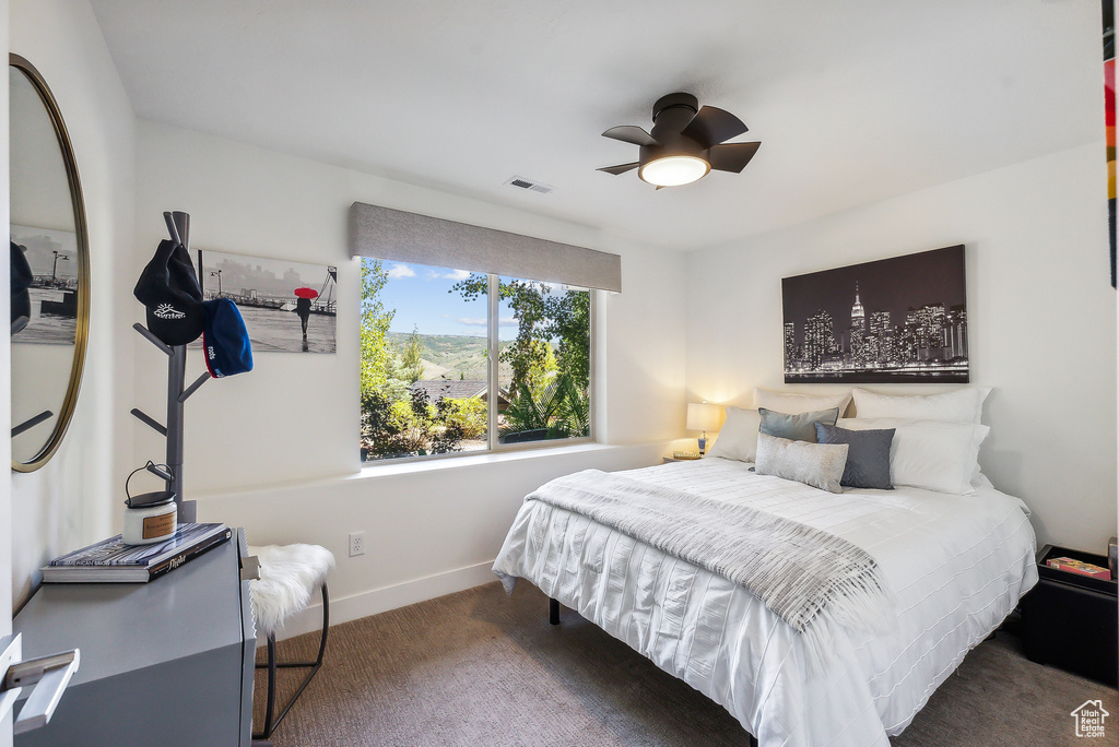 Carpeted bedroom with ceiling fan