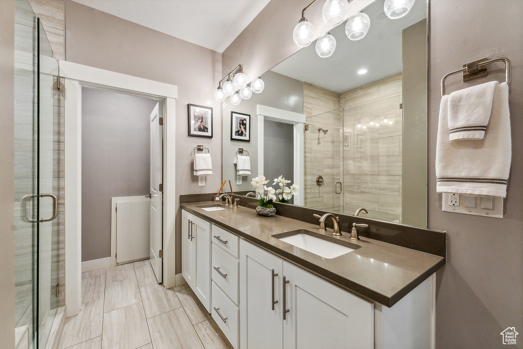 Bathroom featuring walk in shower and vanity