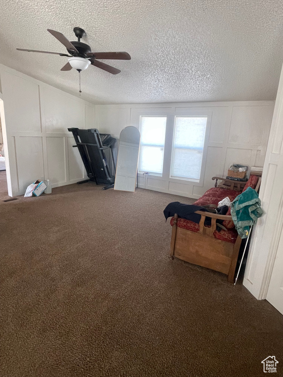 Interior space featuring a textured ceiling, ceiling fan, and carpet floors