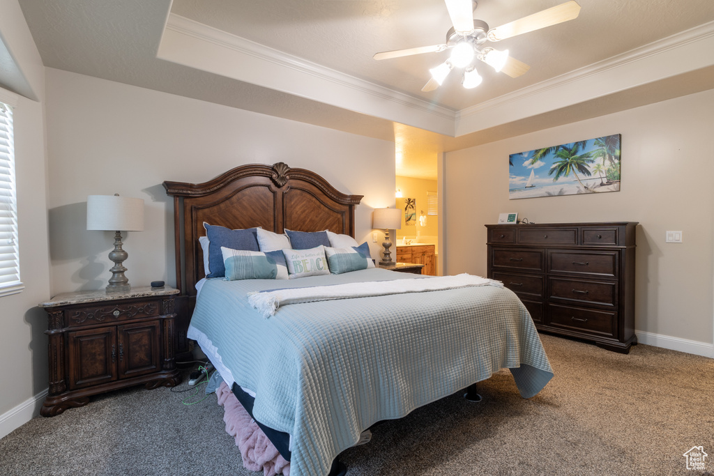 Carpeted bedroom featuring ceiling fan and crown molding