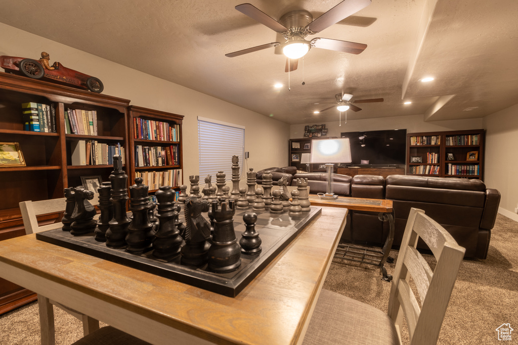 Rec room with ceiling fan and carpet floors