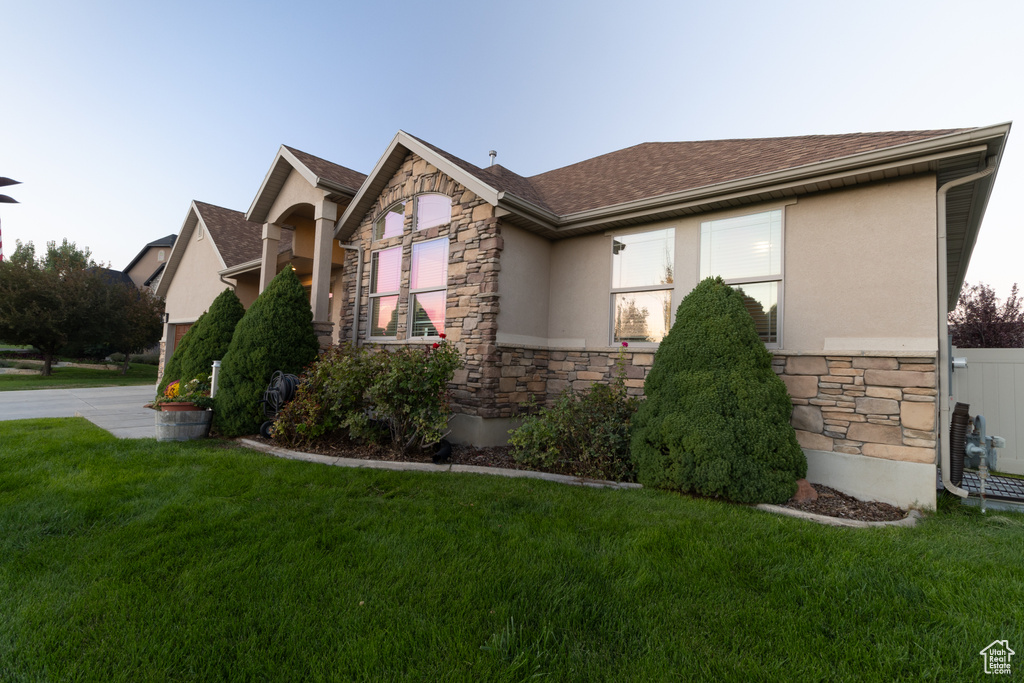 View of side of home with a yard