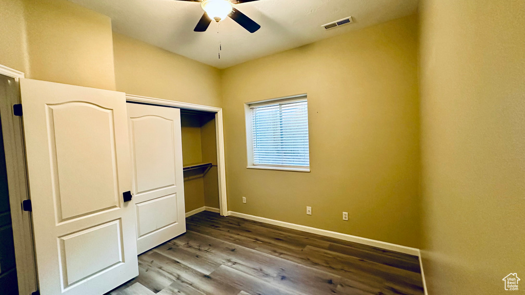 Unfurnished bedroom featuring ceiling fan, a closet, and hardwood / wood-style floors