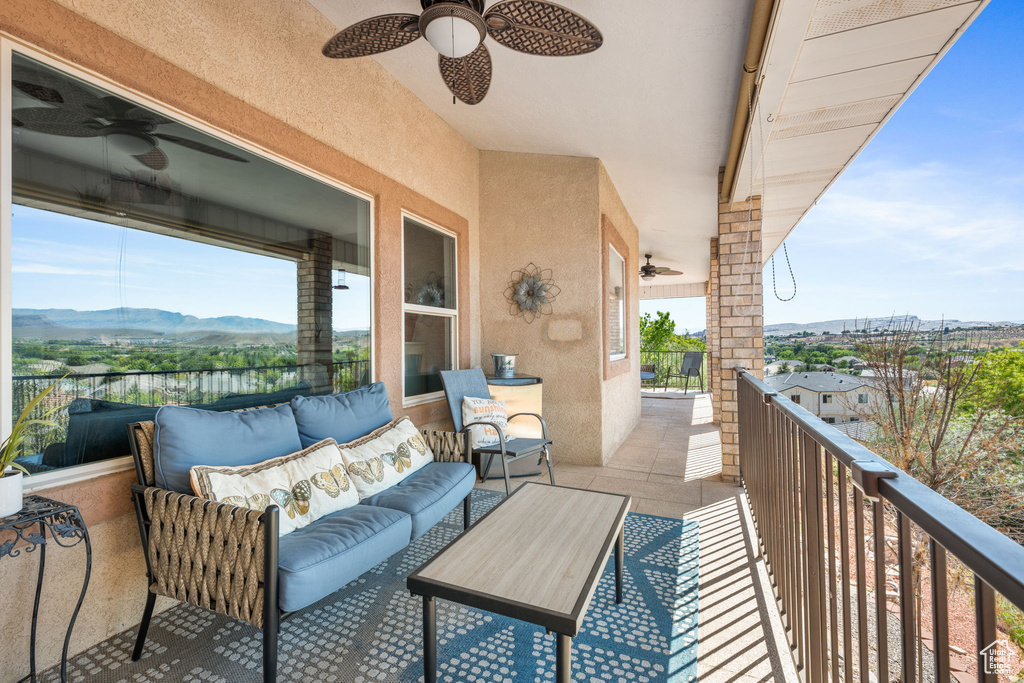 Balcony with a mountain view, an outdoor hangout area, and ceiling fan