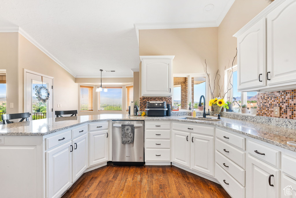 Kitchen with white cabinetry, sink, kitchen peninsula, dark wood-type flooring, and stainless steel dishwasher