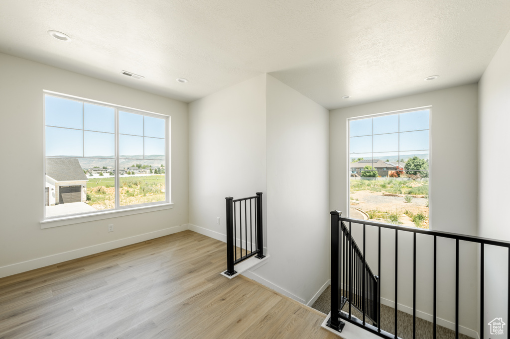 Spare room featuring light wood-type flooring