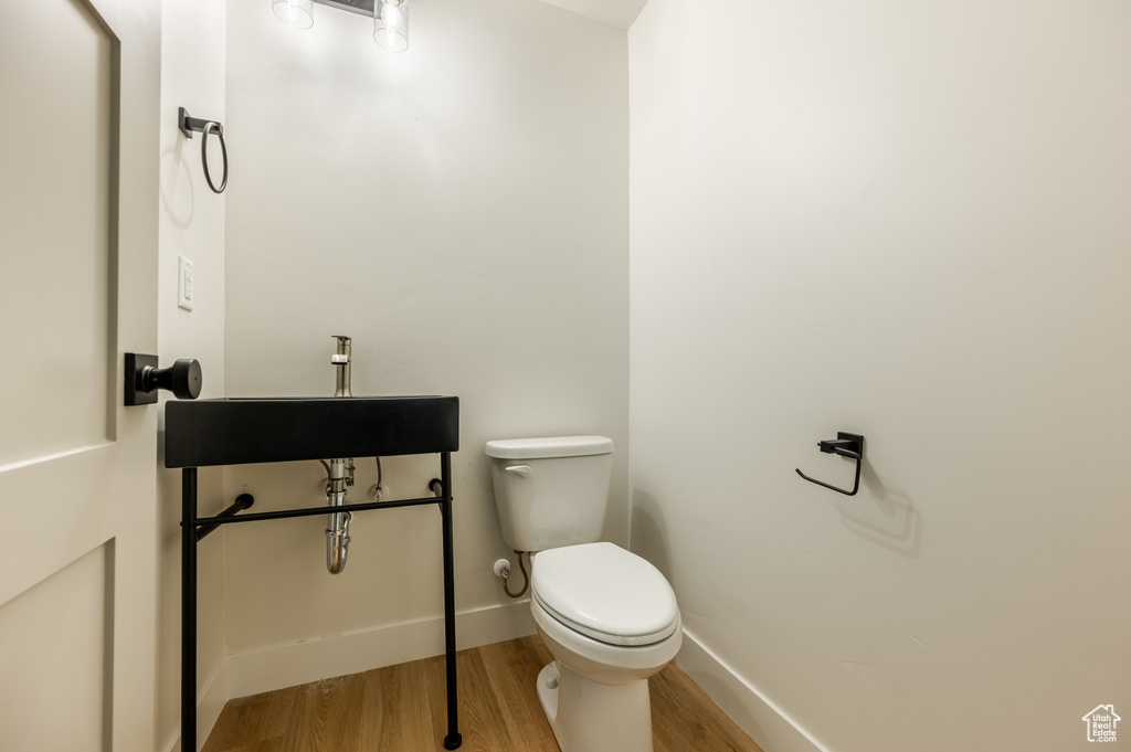 Bathroom featuring hardwood / wood-style floors and toilet