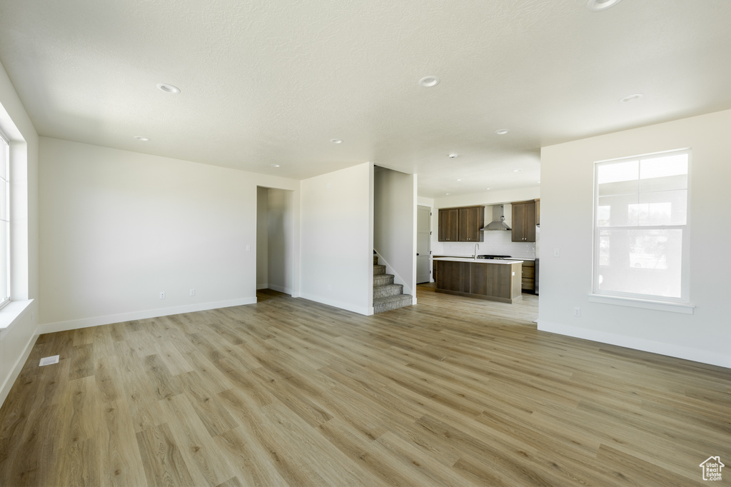 Unfurnished living room with light wood-type flooring