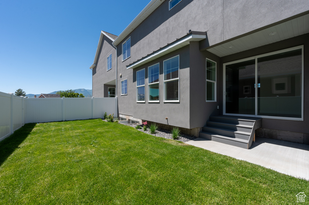 Rear view of property featuring a yard