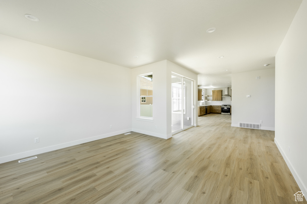 Unfurnished living room with light wood-type flooring