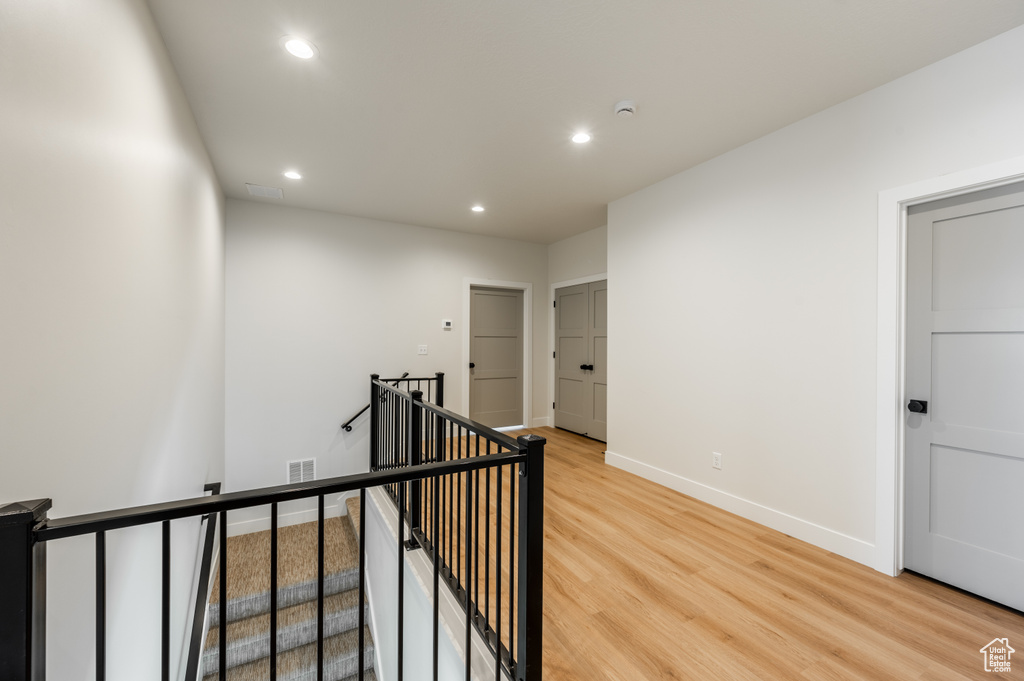 Corridor with light hardwood / wood-style floors