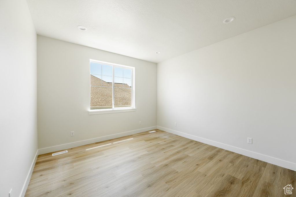 Empty room featuring light hardwood / wood-style flooring