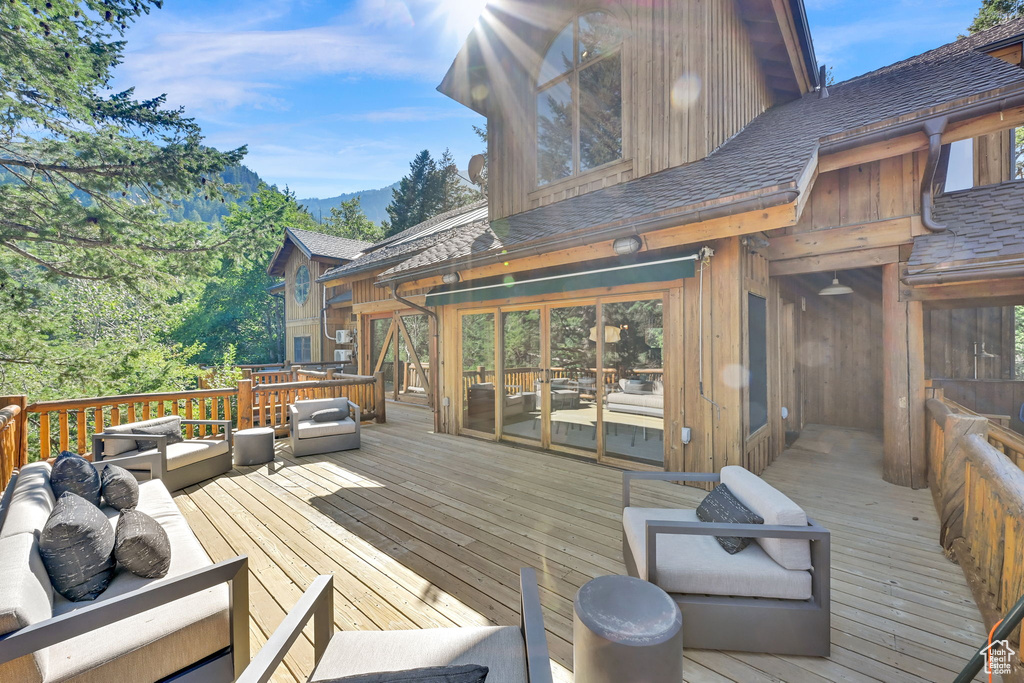 Wooden deck with a mountain view and an outdoor living space