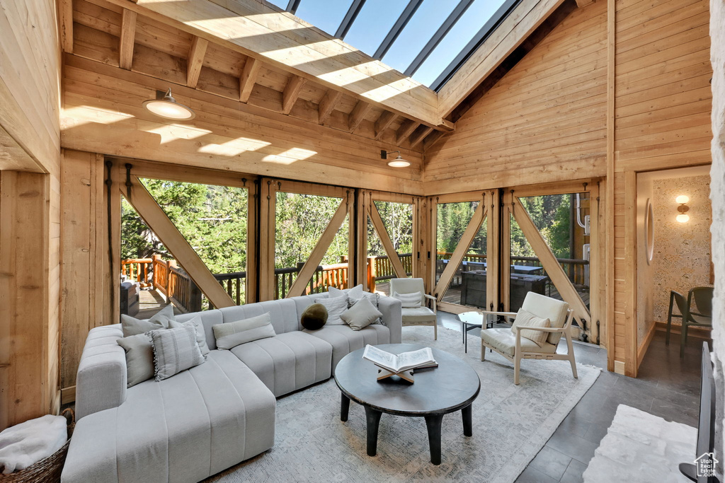 Sunroom featuring lofted ceiling with skylight