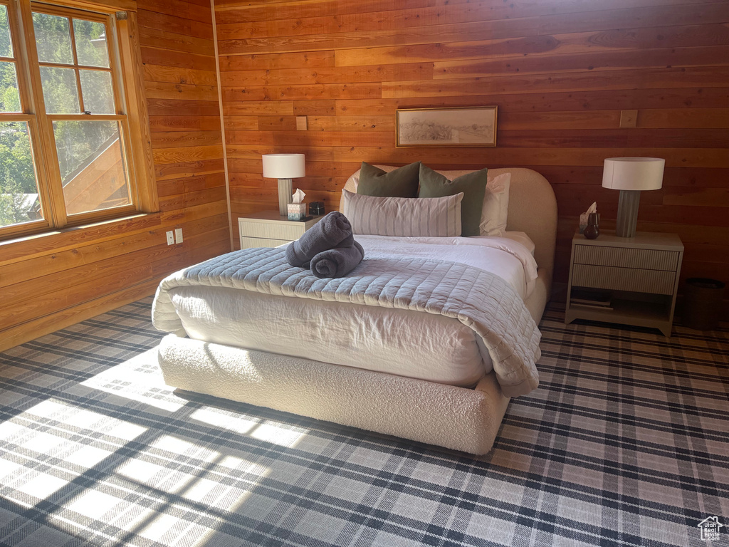 Bedroom featuring wooden walls