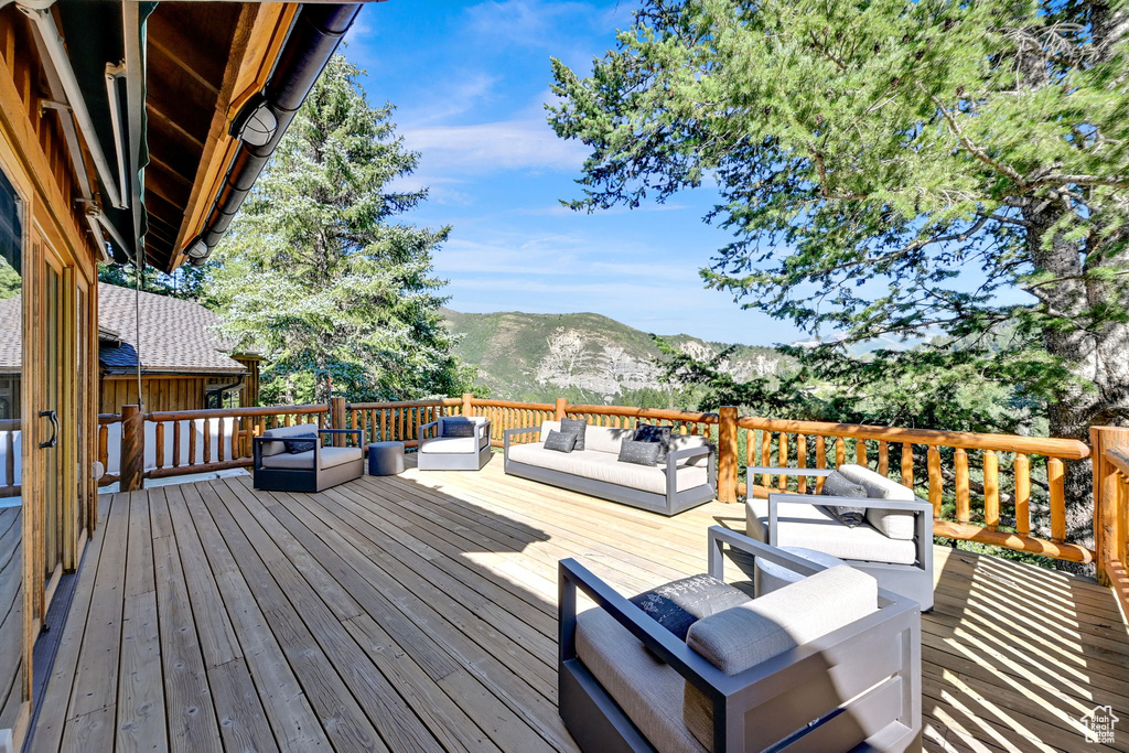 Wooden deck featuring outdoor lounge area and a mountain view