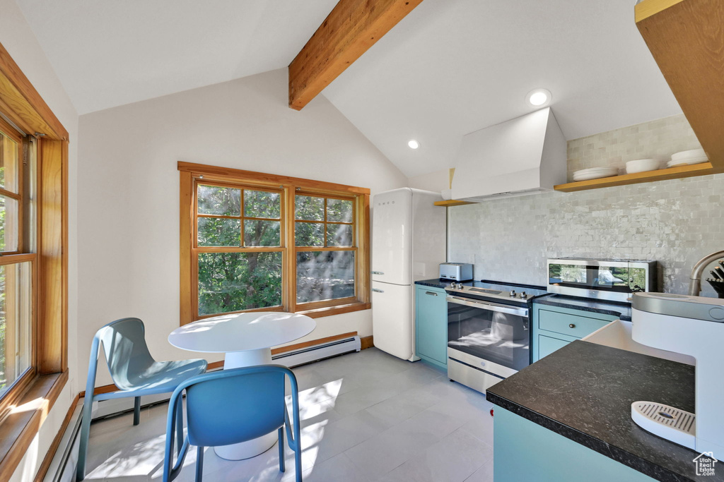 Kitchen with custom exhaust hood, tasteful backsplash, stainless steel appliances, baseboard heating, and lofted ceiling with beams