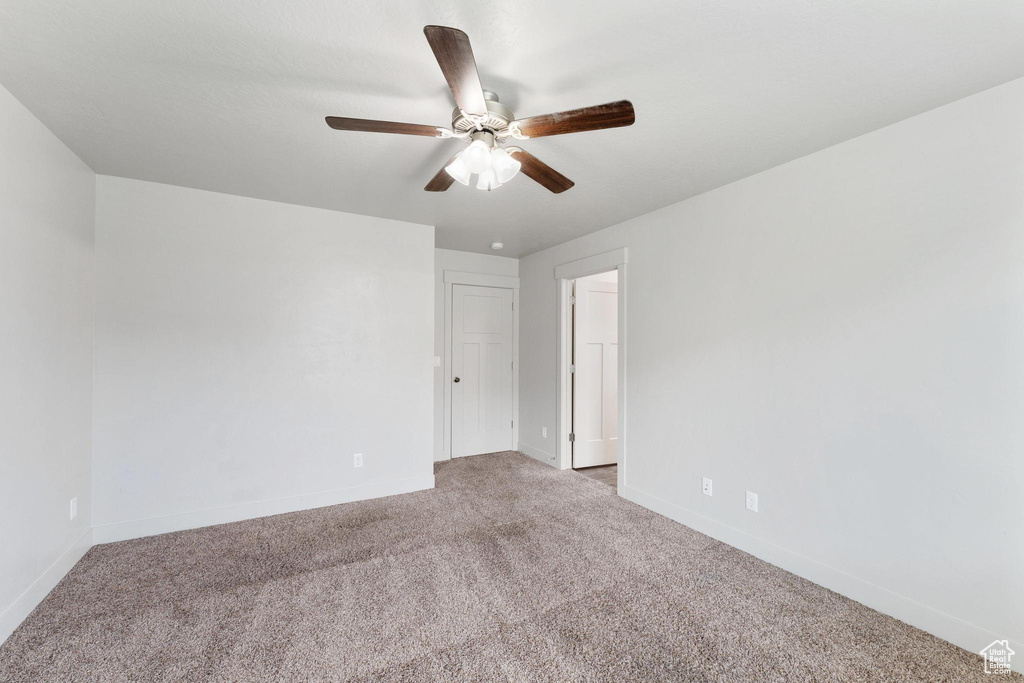 Spare room with light colored carpet and ceiling fan