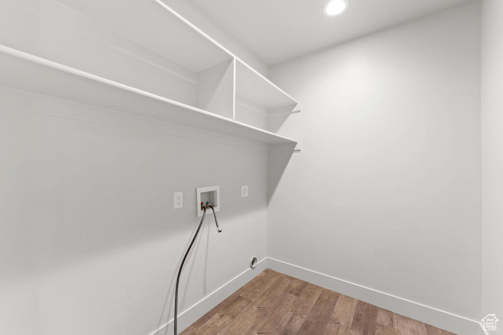 Laundry room featuring washer hookup and hardwood / wood-style floors