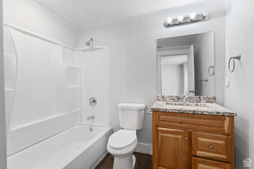 Full bathroom featuring shower / bath combination, toilet, and vanity