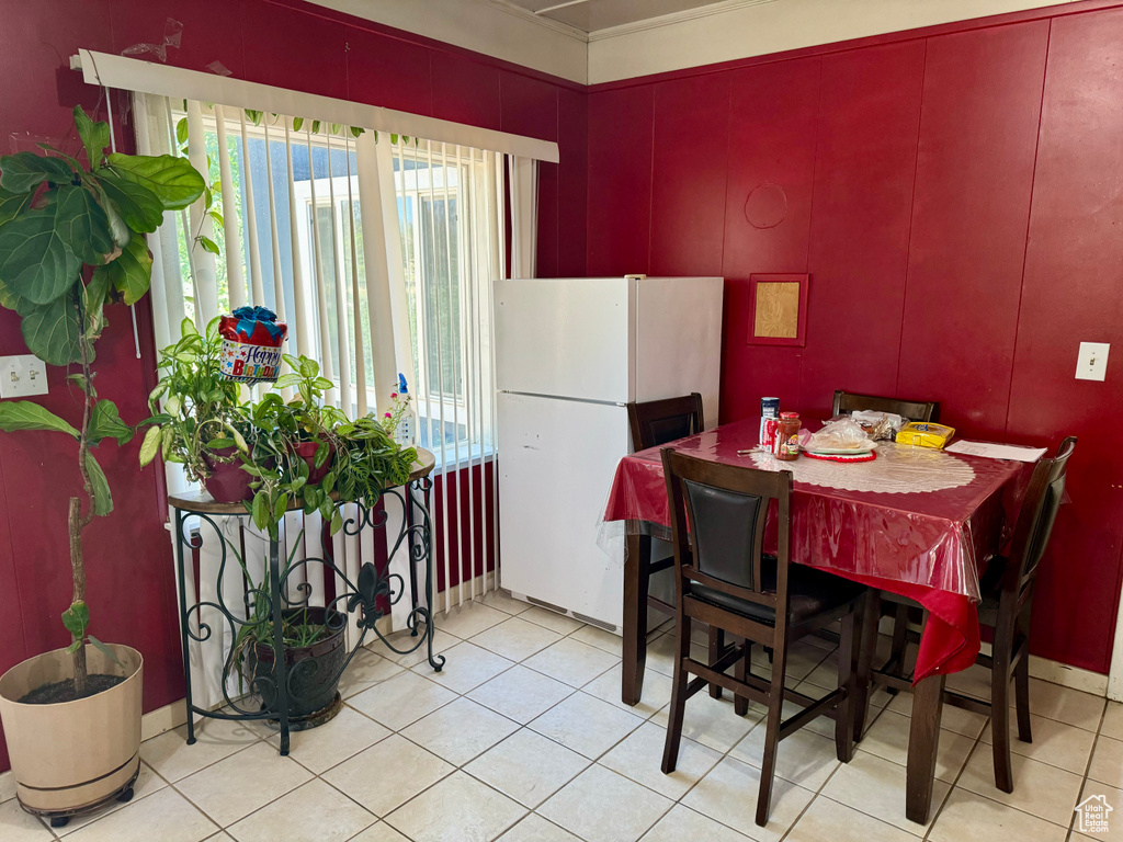 Tiled dining room featuring a wealth of natural light