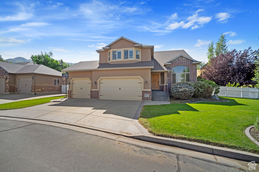 View of front facade with a front yard and a garage