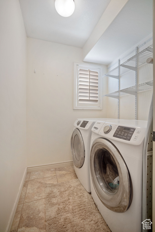 Washroom featuring washing machine and clothes dryer