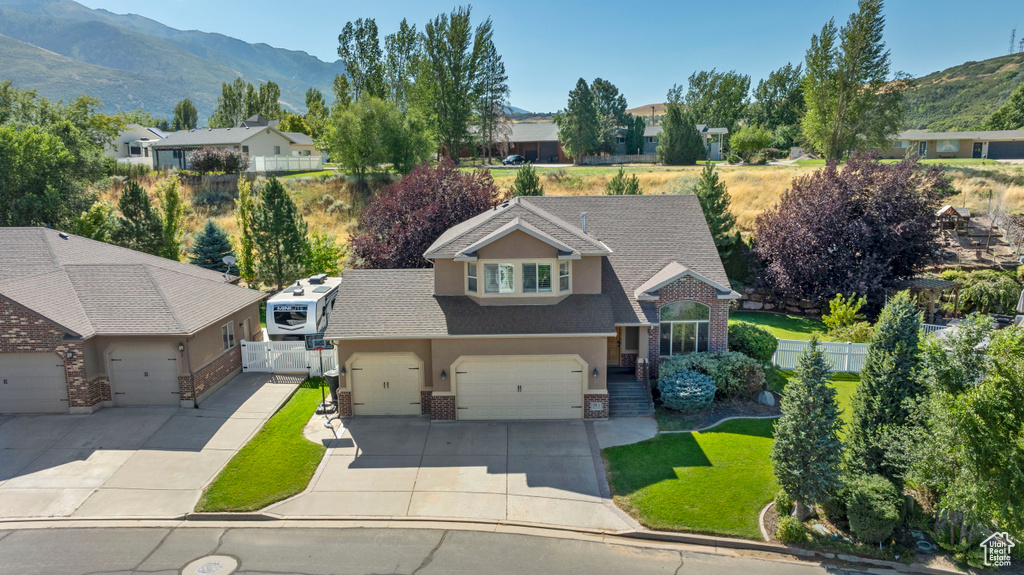 View of front of house featuring a garage and a mountain view