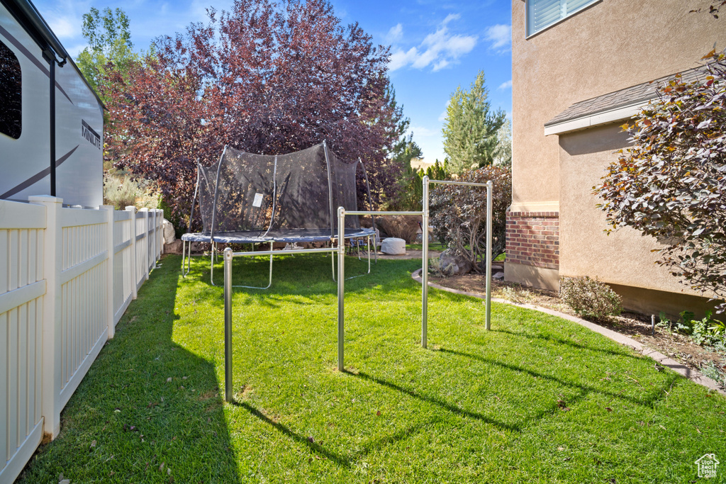 View of yard featuring a trampoline