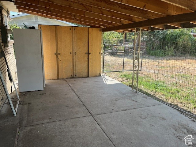 View of patio with a storage shed